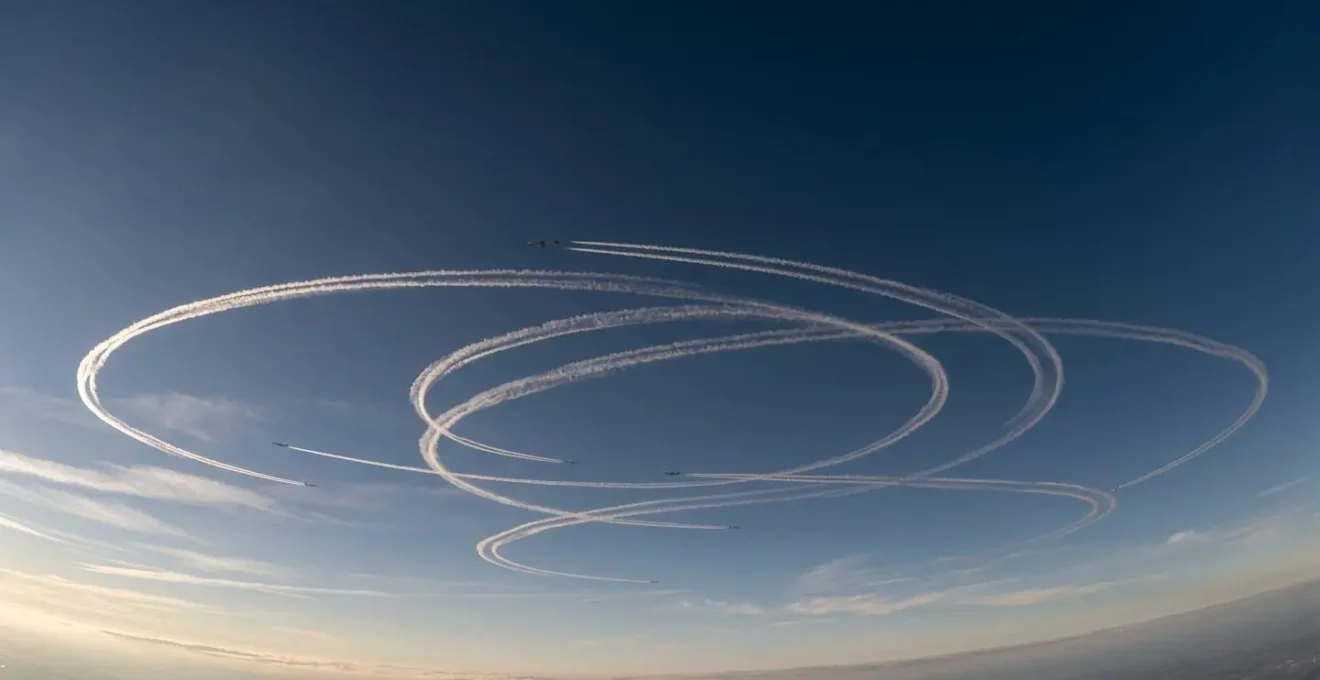 Aerial view of aircraft creating circular holding pattern near major airport with flight path trails visible